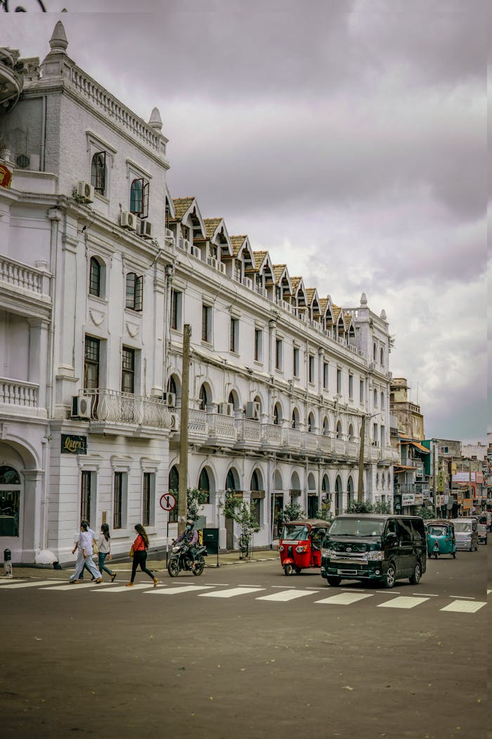 Crafting Captivating Headlines: Your awesome post title goes here A bustling city street with a historic white building, vehicles, and pedestrians.