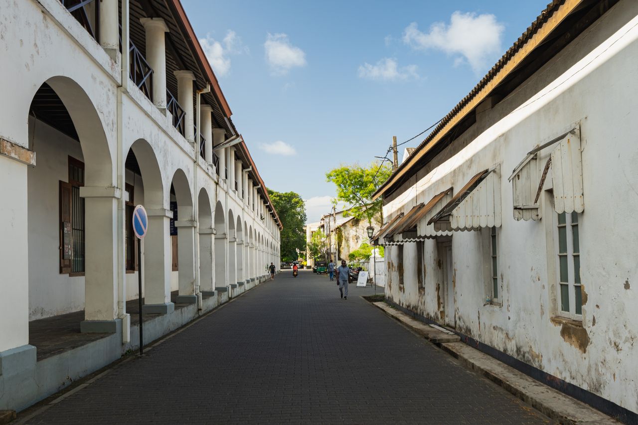 Mastering the First Impression: Your intriguing post title goes here Charming view of a historic street in Galle Fort, Sri Lanka, showcasing colonial architecture and a serene urban environment.