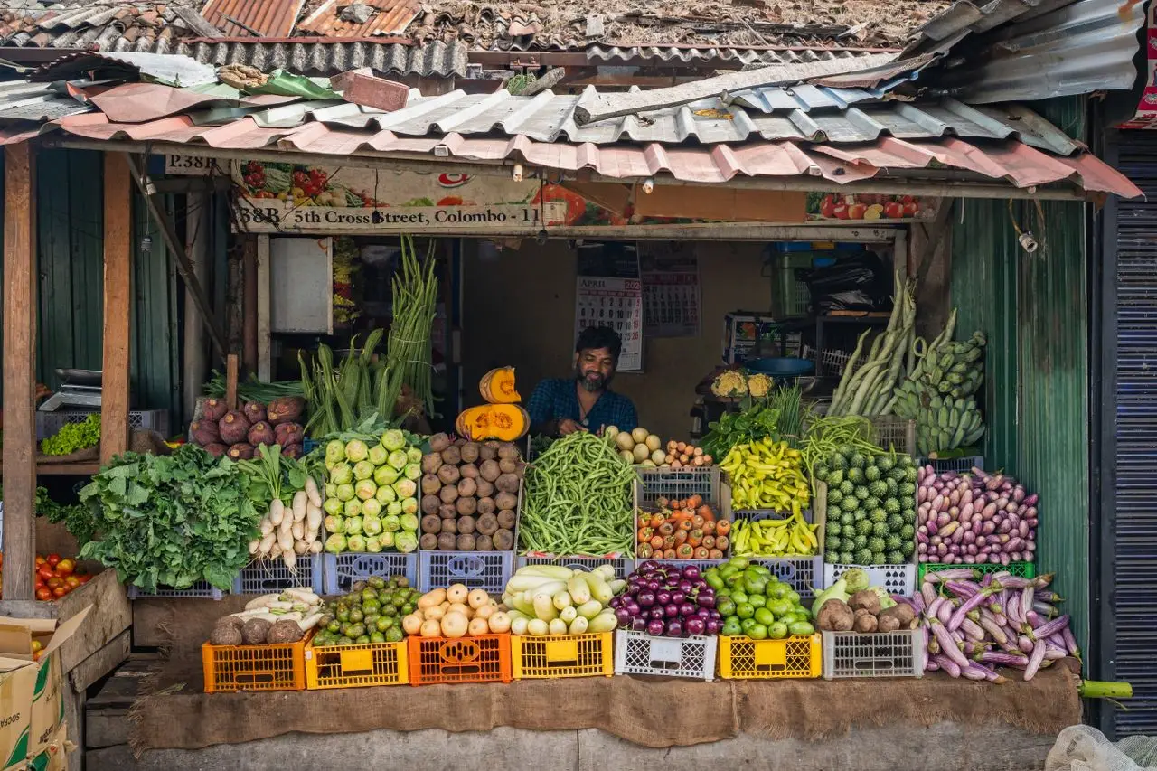 Colorful vegetable stall at 5th Cross Street, Colombo, showcasing fresh produce and local culture.
